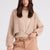Model wearing Anita cashmere cropped cardigan in beige, front view