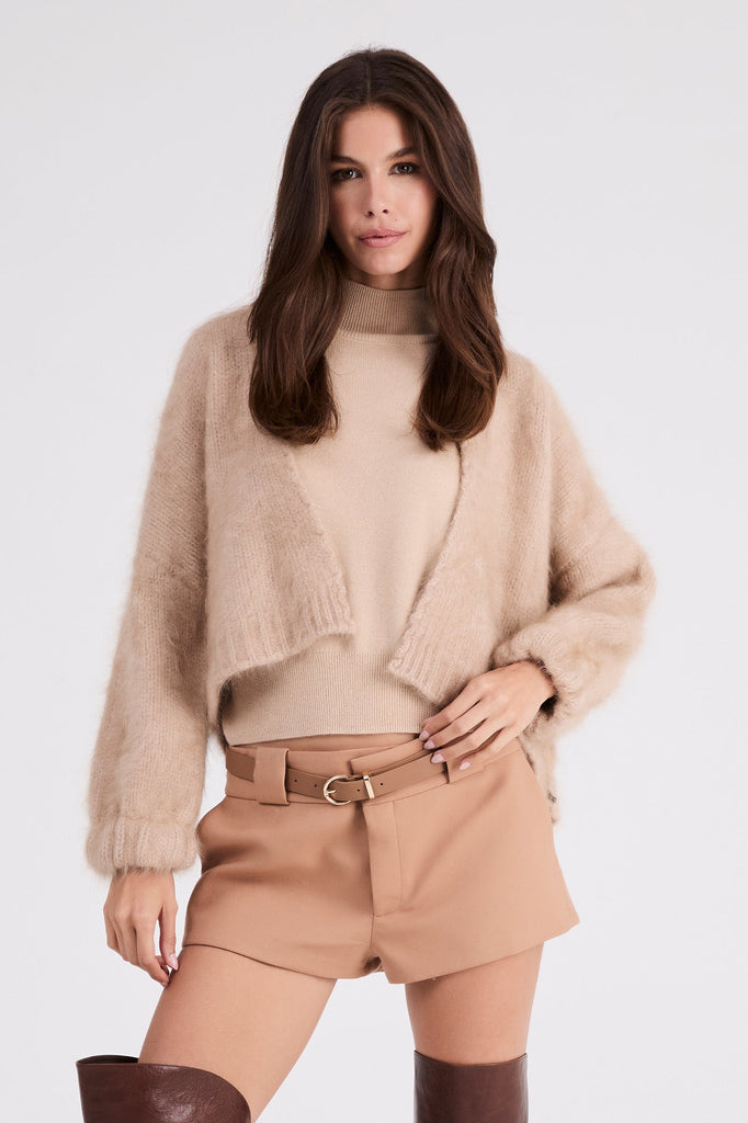 Model wearing Anita cashmere cropped cardigan in beige, front view