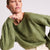 Woman wearing the Stevie green cashmere sweater by Beryll.
