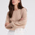 Woman wearing the Stevie beige cashmere sweater by Beryll.