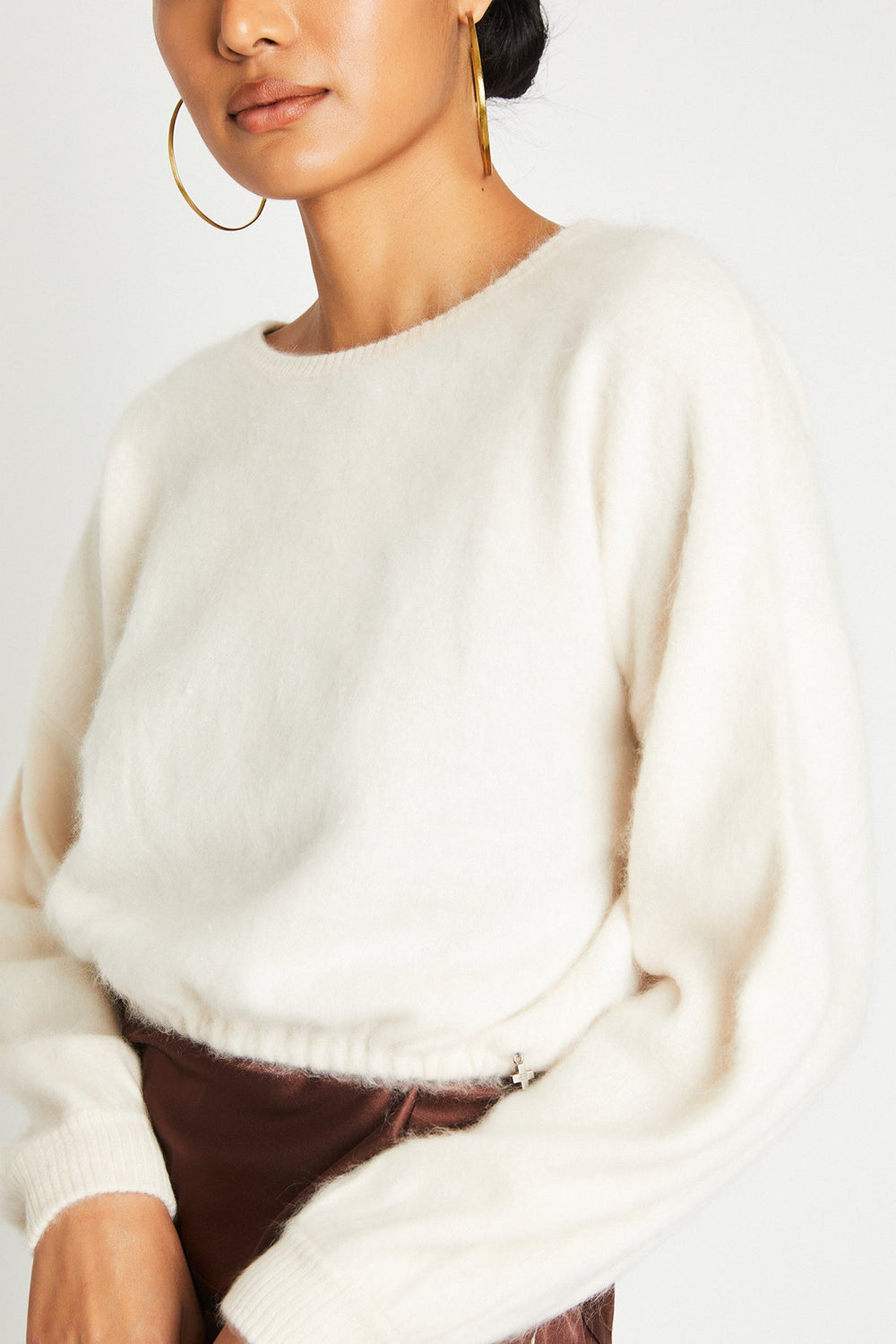 Close-up of the Stevie ivory cashmere sweater showing the premium cashmere knit and gathered waist.