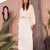 Woman wearing the Stevie ivory cashmere sweater by Beryll with a flowing ivory dress.