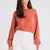 Woman wearing the Stevie coral cashmere sweater by Beryll.