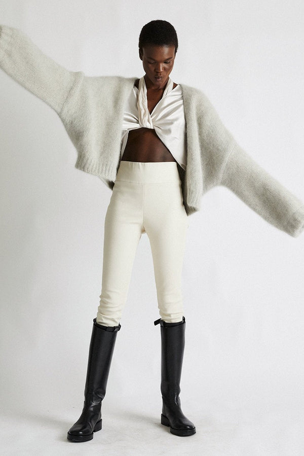 Model wearing Anita cashmere cropped cardigan in light gray, front view