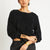 Woman wearing the Stevie black cashmere sweater by Beryll
